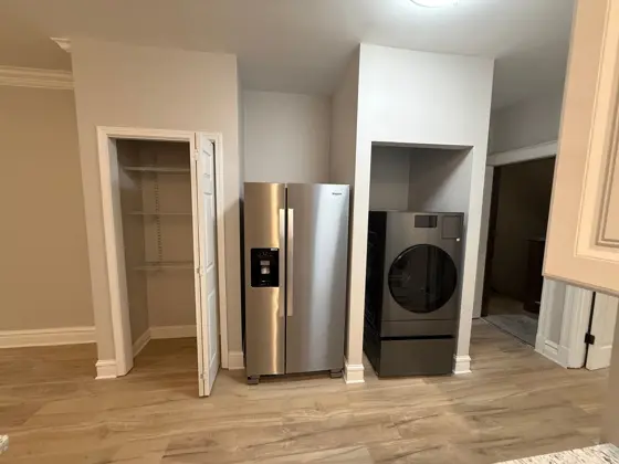 A new fridge and washer installed in a finished space